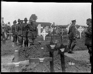 Officers saluting the grave of a fallen comrade