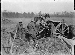 Soldiers loading a howitzer