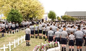 Boys stand by corridor of crosses