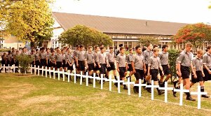 Boys walk between the crosses of Fallen Old Boys